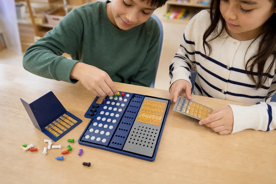 Two learners testing a visual code on the Kodmaster board