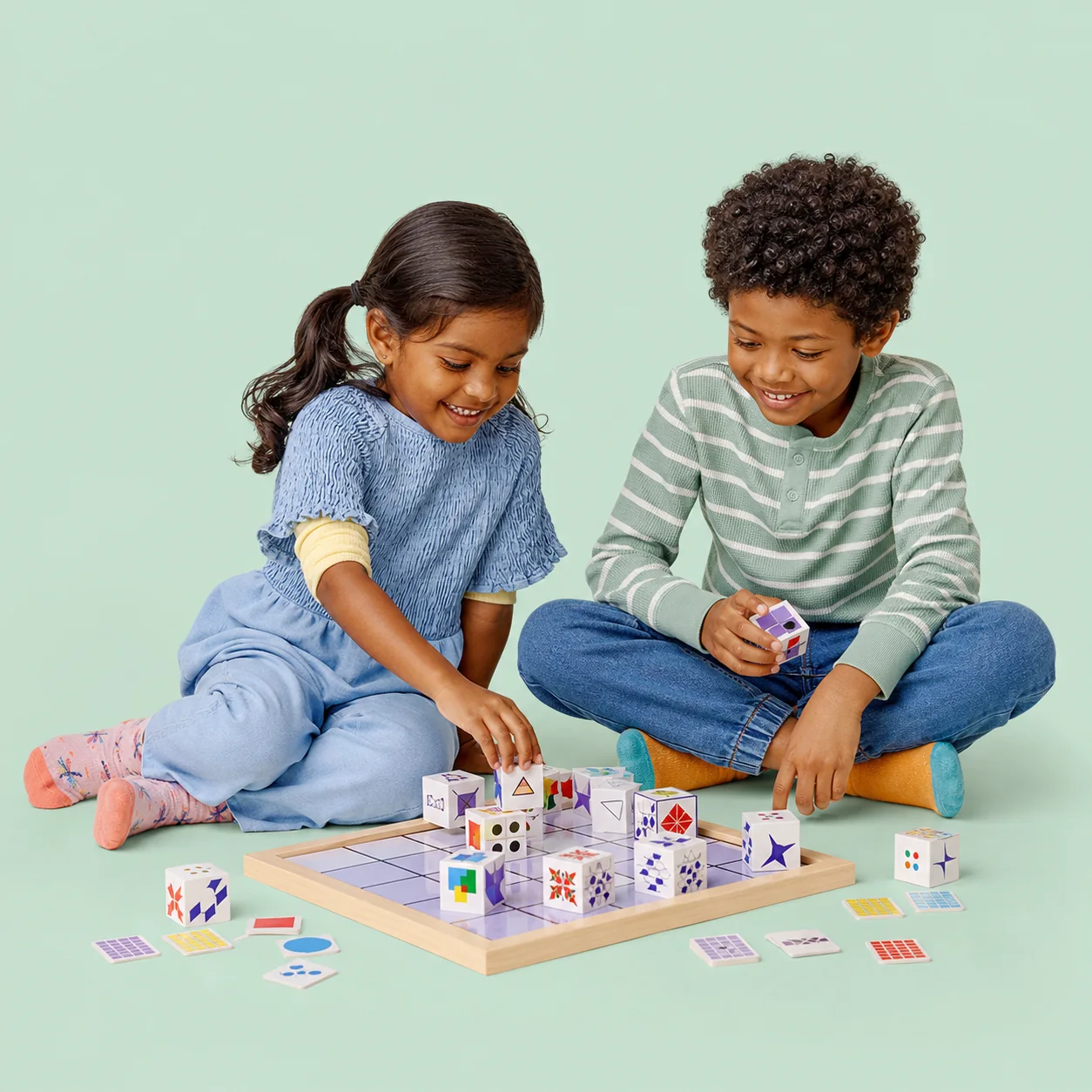 Two children collaborating with a matrix of geometric cubes